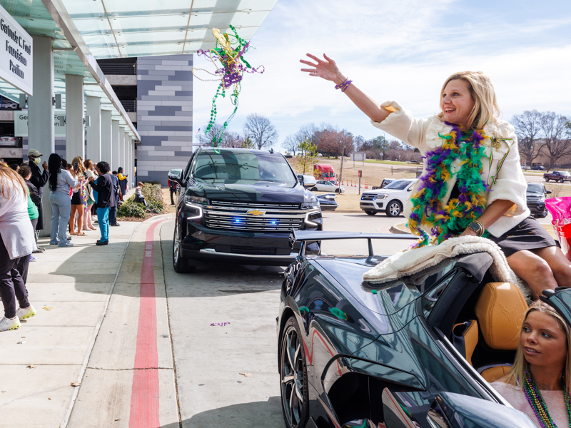 Mississippi First Lady Elee Reeves throws beads during the annual Mississippi Department of Public Safety Mardi Gras parade.