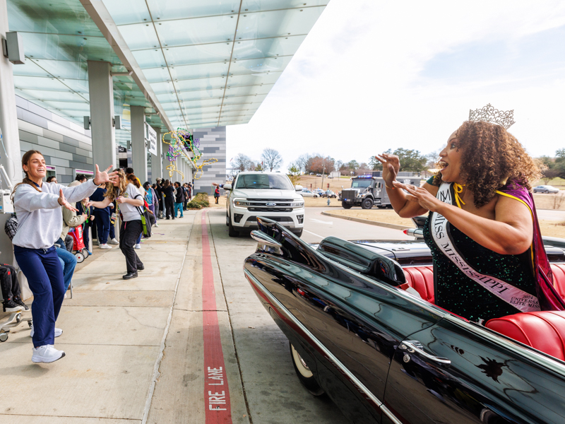 Miss Mississippi Universal Elite Miss Phoebe Harris throws beads during the Mississippi Department of Public Safety's Mardi Gras parade.