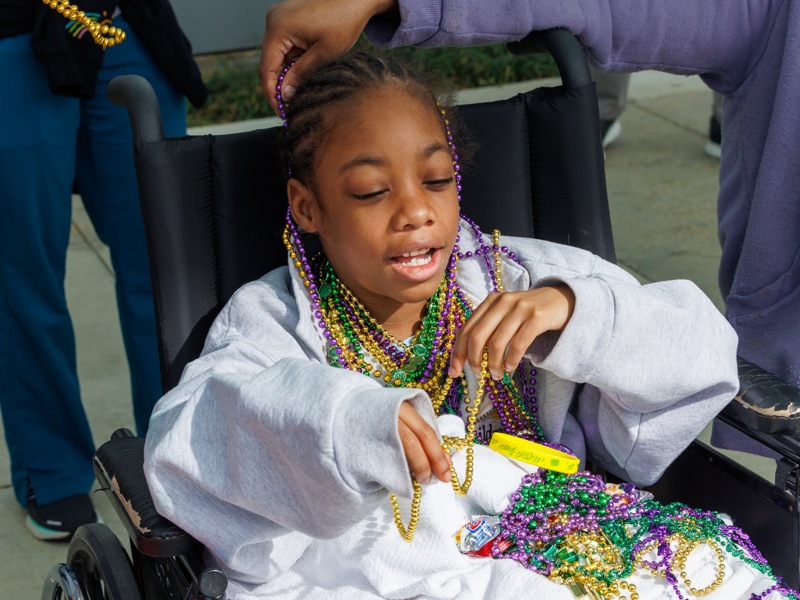 Children's of Mississippi patient Ashanti Blockmon of Jackson enjoys her collection of Mardi Gras beads and parade throws.