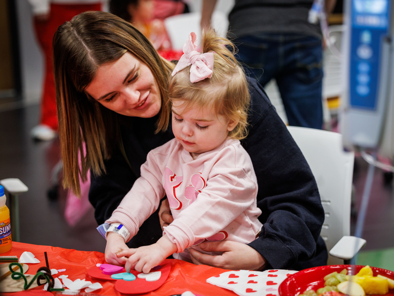 Children's of Mississippi patient Adley Thomas and her mom, Madison, of Rayville, Lousiana, work on a Valentine's Day art project. Jay Ferchaud/ UMMC Photography