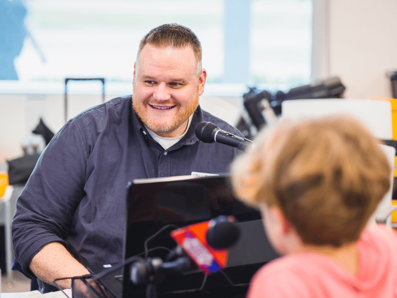 On-air personality and production director Fisher Alexander of U.S. 96 interviews Aiden Robinson during the 2023 Mississippi Miracles Radiothon.