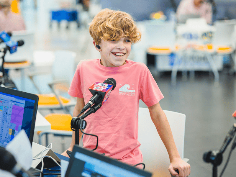 Children's of Mississippi patient Aiden Robinson of Brandon smiles between interviews during the 2023 Mississippi Miracles Radiothon.