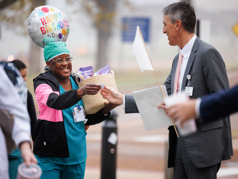 Marc Rolph, executive director of communications and marketing, greets faculty and staff with stickers during Patient Safety Week. Joe Ellis/ UMMC Photography 