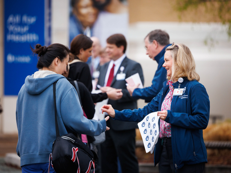 Dr. Kimberly Crowder, chair of the ophthalmology department, passes out stickers to faculty and staff during Patient Safety Week. Joe Ellis/ UMMC Photography 