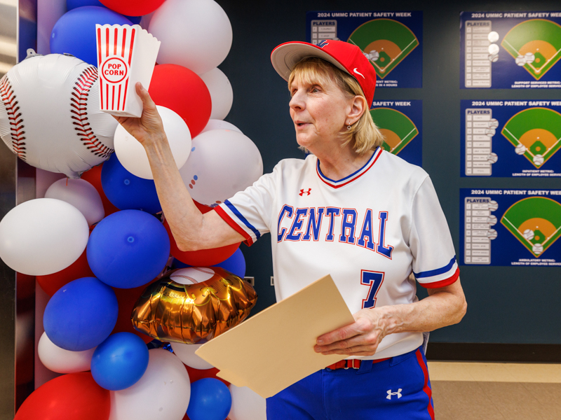 Phyllis Bishop sports a baseball uniform in spirit of the Patient Safety Week theme: Cover Your Bases. Jay Ferchaud/ UMMC Photography 