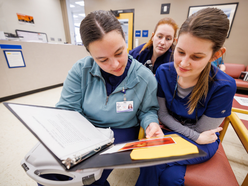 Dental Hygiene students, from left, Katherine Dumas, Mary Jordan Milton and Blakeney Burney discuss a patients care during the meeting before the after hours dental clinic opens.