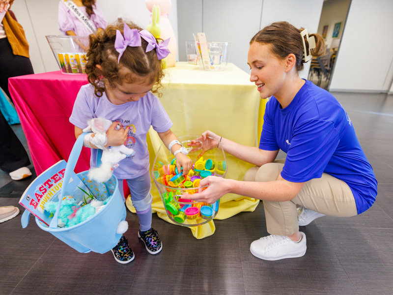Children's of Mississippi patient Katalina Fernald of Morton chooses Easter surprises with a little help from Laney Butts, brand coordinator for Trustmark.