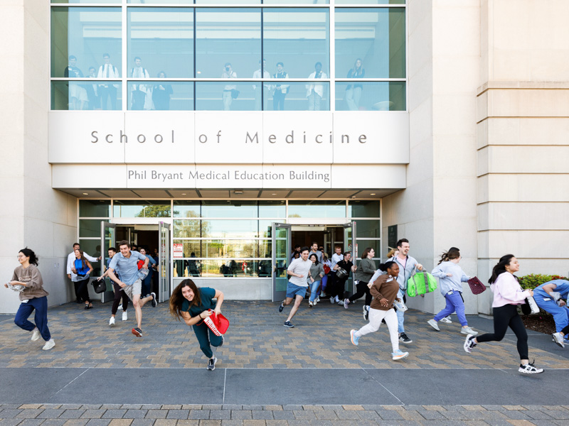 Medical students scramble to gather the Easter eggs that dot the greenspaces around the School of Medicine.