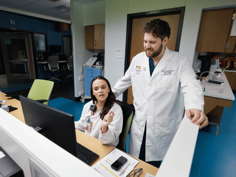 PICU nurse manager Gordon Gartrell talks with registered nurse Caroline Swayze at the pediatric intensive care unit in the Kathy and Joe Sanderson Tower at Children's of Mississippi.
