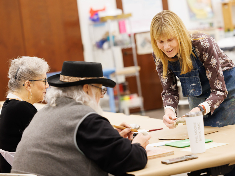 Libby and Charlie Hewitt, seated, join Susan Anand, a licensed art therapist and instructor in the UMMC Department of Psychiatry and Human Behavior, in creating art from a lump of clay during a session of Art in Mind. "Susan is so encouraging," Libby Hewitt says.