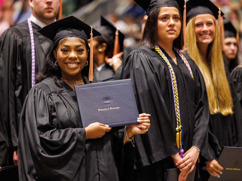 Maya Anderson, a Bachelor of Science in Nursing graduate, displays her ticket to a health care career. Jay Ferchaud/ UMMC Communications 