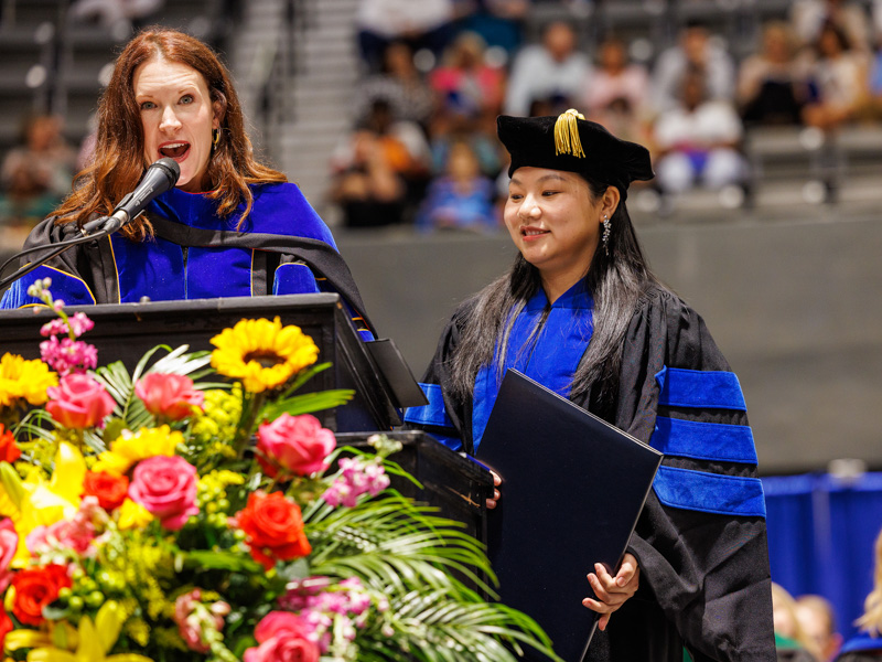 School of Graduate Studies in the Health Sciences graduate Xing Fang, right, receives the Robert A. Mahaffey, Jr. Memorial Award which recognizes the exceptional research potential of young investigators. She accepts the honor from Dr. Sydney Murphy, dean of the school. Jay Ferchaud/ UMMC Communications