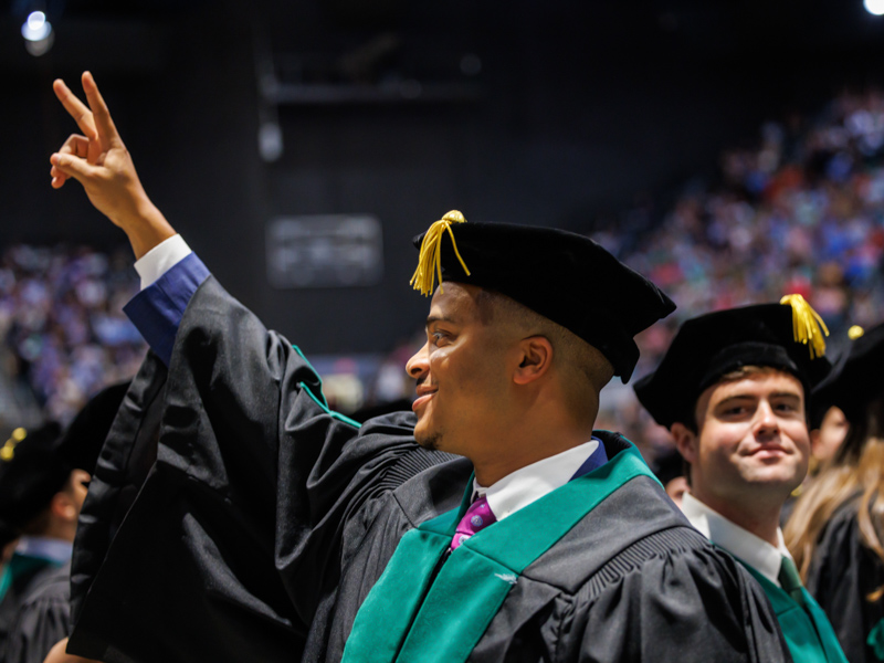 School of Medicine graduate Eric Lucas Jr. signs off on a glorious Commencement Day. Jay Ferchaud/ UMMC Communications 