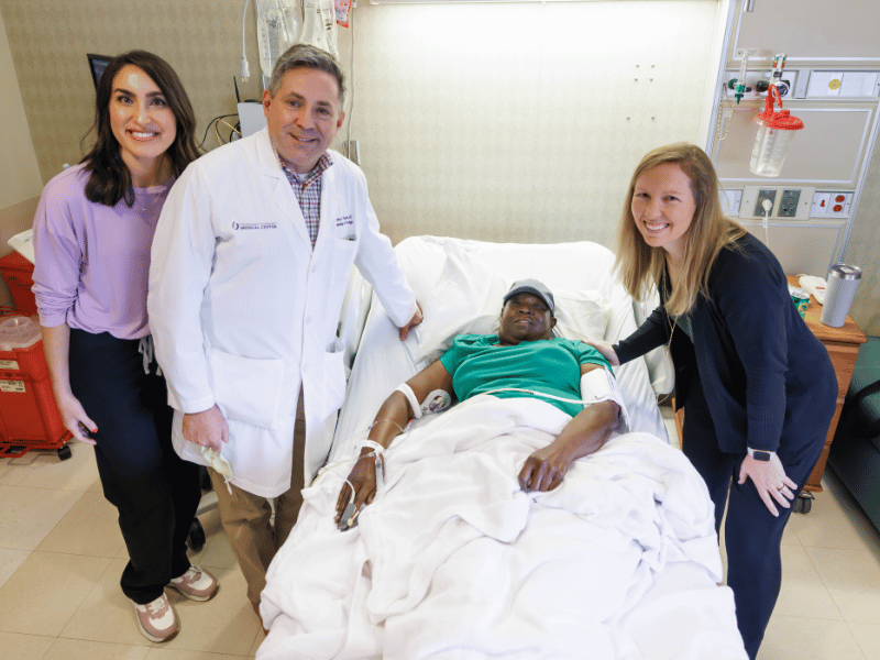 Hurrod is visited by Ashley Peden, nurse practitioner; Dr. Vince Herrin, professor of hematology and oncology and bone marrow transplant specialist; and Dr. Carter Milner, professor of hematology and oncology and bone marrow transplant.