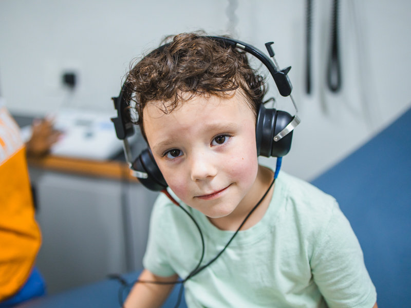 Dalton Karnitz wears headphones for a hearing test.