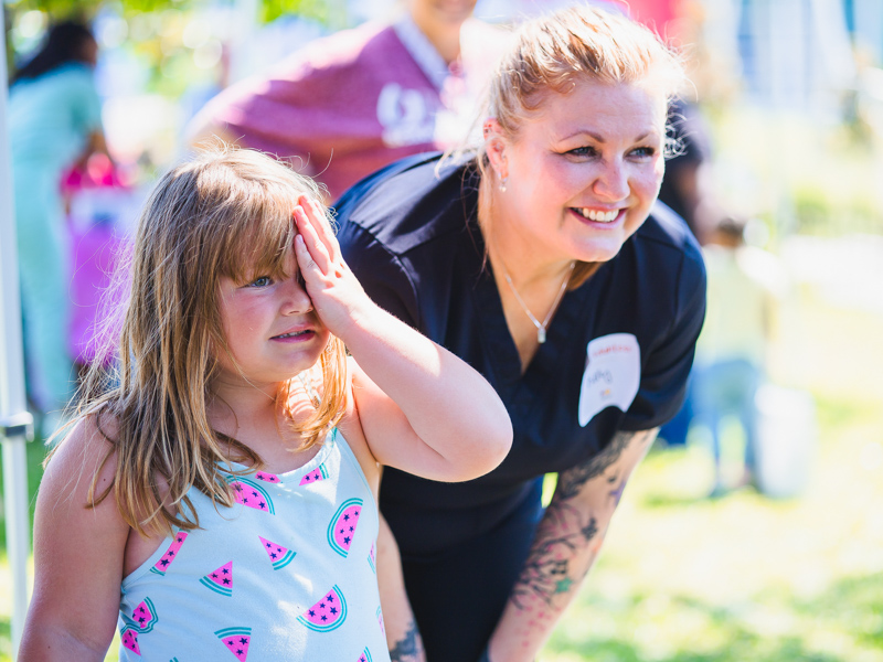 Registered nurse Kelly Burns gives Aria Wellborn a vision screening.