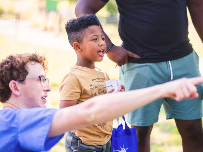Fourth-year medical student Spencer Hagwood interacts with Back-to-School Health Rally attendee Elijah Carter.
