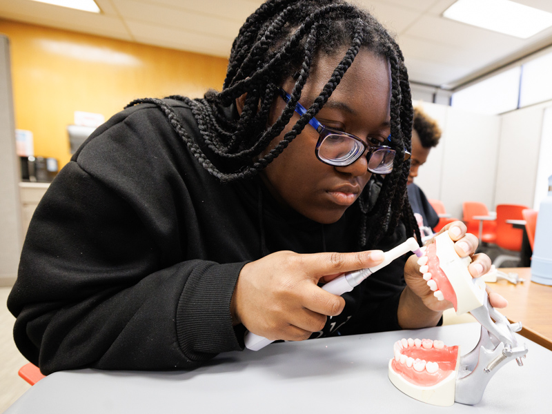 Student Kylie Jones polishes teeth like a pro at S.M.I.L.E. U