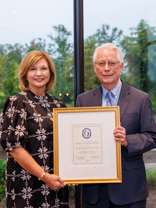 Dr. LouAnn Woodward presents the Medical Hall of Fame Award to Dr. Thad Waites.