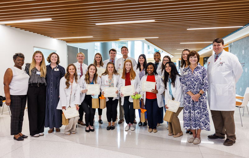 Pediatric Research and Clinical Education Program (PReCEP) participants smile with, from left, Tzatwanda Dixon, Mackenzie Nichols, Dr. Cynthia Karlson, and, right, Dr. Mary Taylor and Dr. David Gilliam.