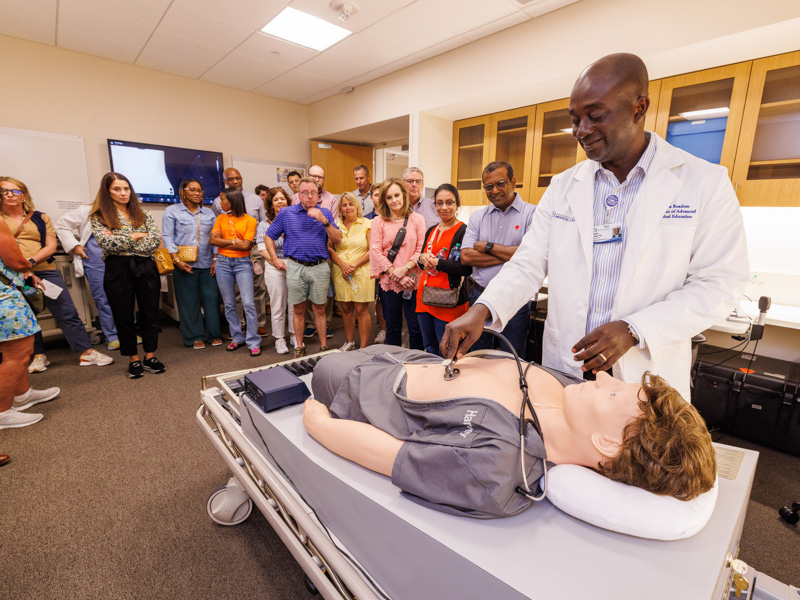 Dr. Oheneba Boadum, assistant professor of advanced biomedical education, demonstrates use of a medical manikin during Family Day at the School of Medicine. Jay Ferchaud/ UMMC Communications