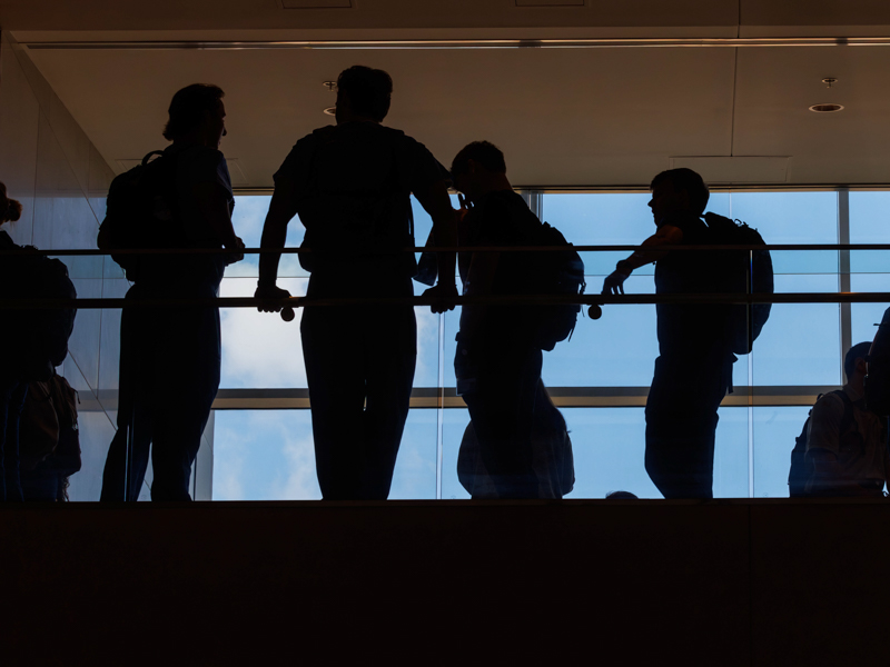 Medical students are silhouetted against the large windows on the second floor of the School of Medicine. Melanie Thortis/ UMMC Communications