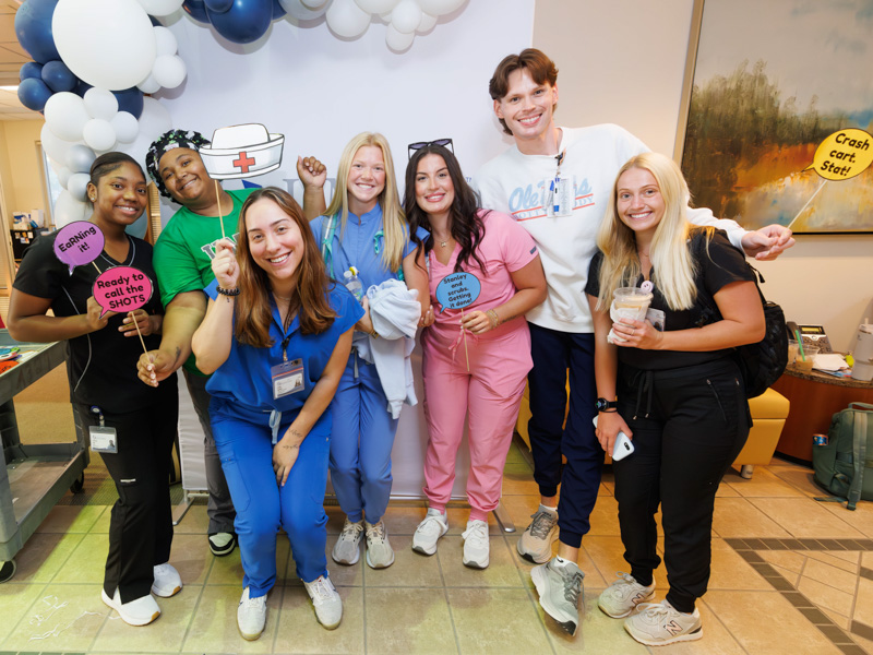 Nursing students, from left, Zy'Keria Cole, Makayla Bailey, Ashlee Ippolito, Camille Cottone, Mary Elizabeth Lewis, Brady Pinter and Corine Thier pose for photos following a back-to-school grab-and-go breakfast. Melanie Thortis/ UMMC Communications