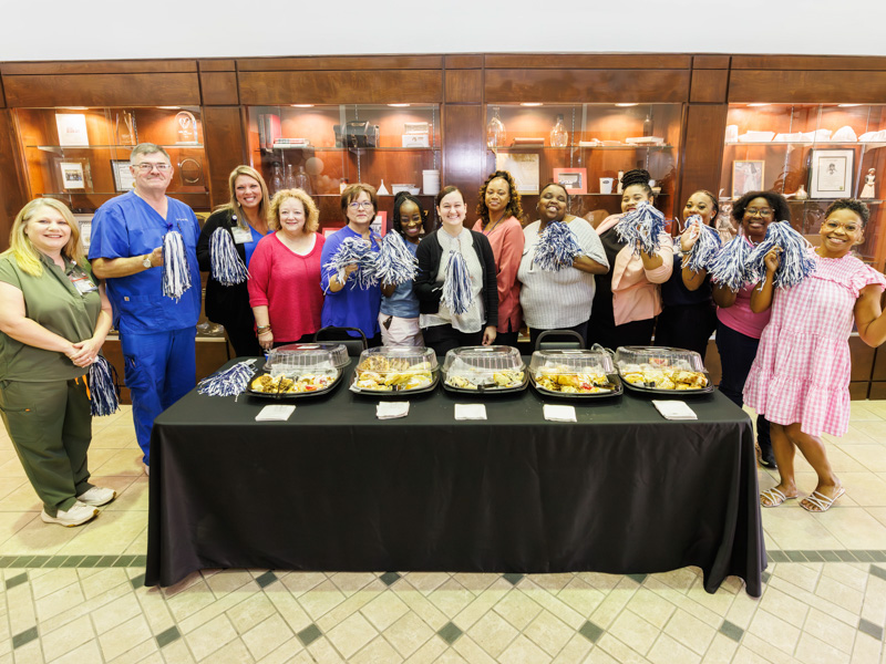 School of Nursing faculty and staff wave pompoms during a back-to-school breakfast for nursing students. Melanie Thortis/ UMMC Communications