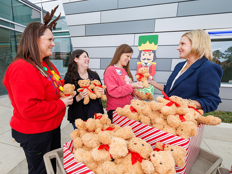 Elee Reeves, right, wife of Gov. Tate Reeves, talks with, from left, child life specialists Pepper Weed-Cooper and Kelsey Clark, and Cara Williams, child life manager.