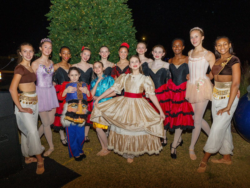 Dancers from Ballet Mississippi smile beside the Children's of Mississippi Christmas tree after BankPlus Presents Light-A-Light, the oldest fundraiser for Friends of Children's Hospital. Jay Ferchaud/ UMMC Communications