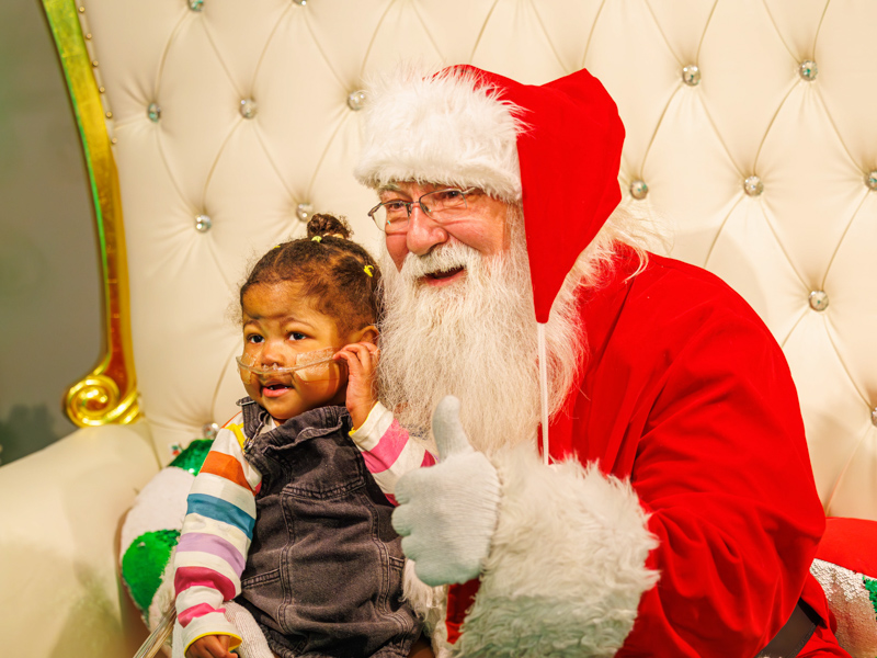 Children's of Mississippi patient LaMiracle Reasor of Waynesboro visits with Santa during BankPlus Presents Winter Wonderland and Ace Tree Farm. Melanie Thortis/ UMMC Communications