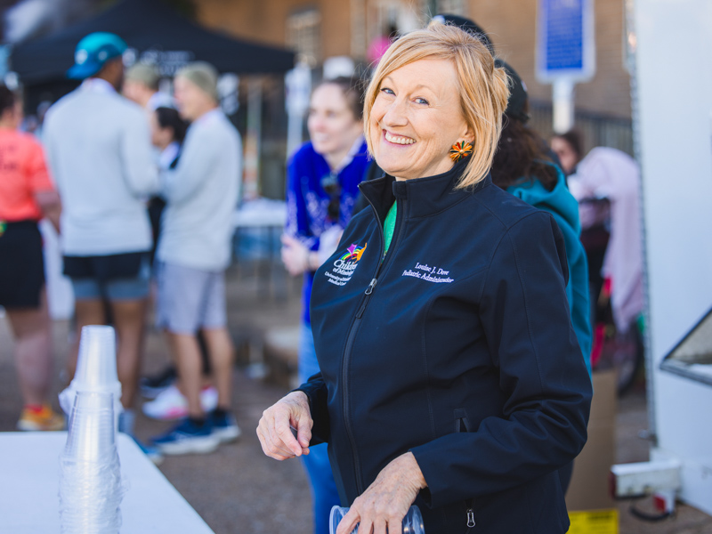 Louise Dove, Department of Pediatrics business development manager, smiles while volunteering Sunday.