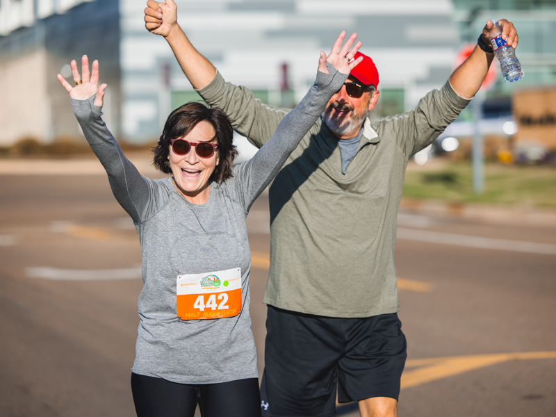 Dr. Mary Taylor, Suzan B. Thames Chair and professor of pediatrics, and her husband, Michael Taylor, wave during the half marathon.