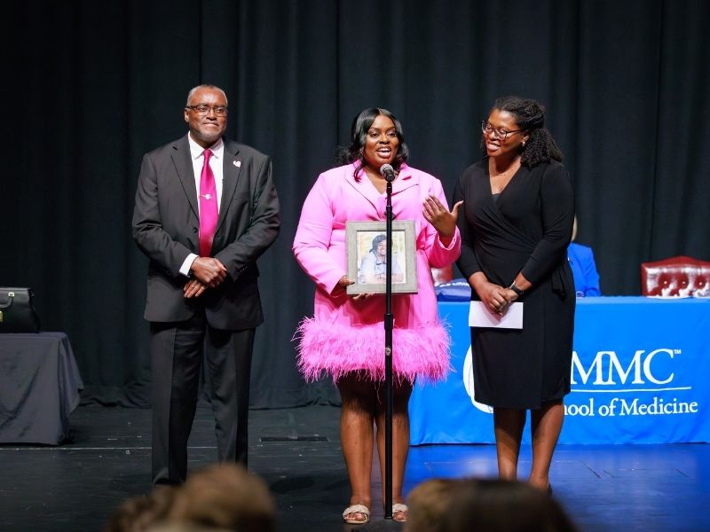 While announcing her match, Mia McFadden, with dad, Joe McFadden, and sister, Kiana McFadden, holds a photo of her mom, Demarius McFadden, who died of breast cancer in 2018. Mia, who matched in obstetrics-gynecology at LSU-Baton Rouge, said her mom "was an integral part of my being here."