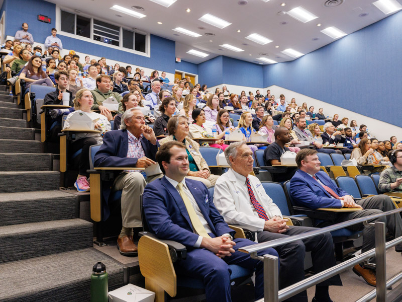 Some in attendance for the 2025 Last Lecture included, from bottom left, Will Farmer, fourth-year dental student who introduced Dr. William Daley; Dr. John Hall, chair of physiology and biophysics; Dr. Diane Beebe, retired chair of family medicine; and Bill King, her husband.