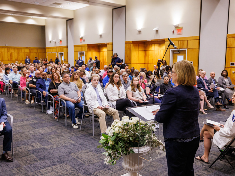 Dr. LouAnn Woodward, UMMC vice chancellor for health affairs and dean of the School of Medicine, addresses members of anatomical donor families, along with students, faculty and staff, gathered for the Ceremony on Thanksgiving. “Without saying a word, your loved one helped teach anatomy, physiology, pathology,” Woodward said to the donor families.