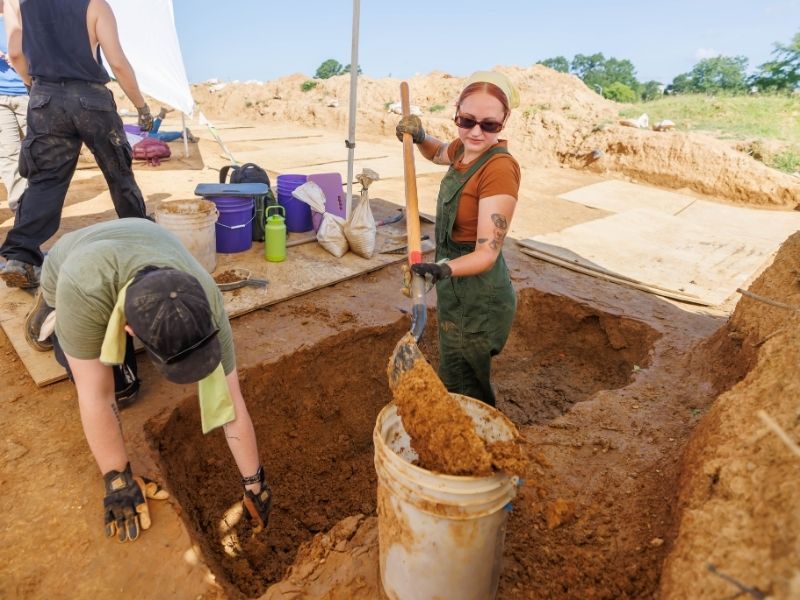 Arizona native Ivy Toleson digs the grave shaft following an excavation with fellow student Gavin Tunnel of New Mexico as part of the Asylum Hill Project field school learning experience.