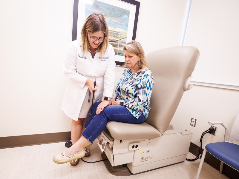 Lyndsey Dill, nurse practitioner in adult and gerontology acute care, tests Liz Anderson's reaction times as part of a study by The MIND Center seeking to understand the causes of brain aging and dementia.