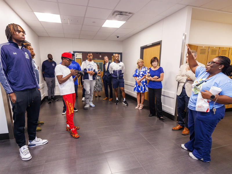 Dr. Mobolaji Famuyide, chief of pediatric neonatology, tells Jackson State University basketball players more about the NICU space inside the Kathy and Joe Sanderson Tower at Children's of Mississippi. Jay Ferchaud/ UMMC Communications