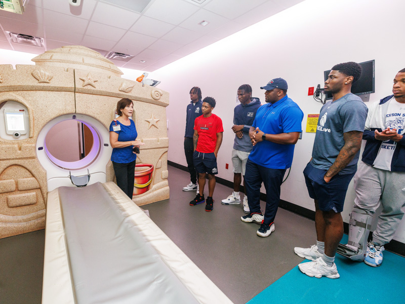 Dr. Mary Taylor, Suzan B. Thames Chair and professor of pediatrics, gives Jackson State University basketball players a tour of Children's of Mississippi's Imaging Center at the Kathy and Joe Sanderson Tower. Jay Ferchaud/ UMMC Communications