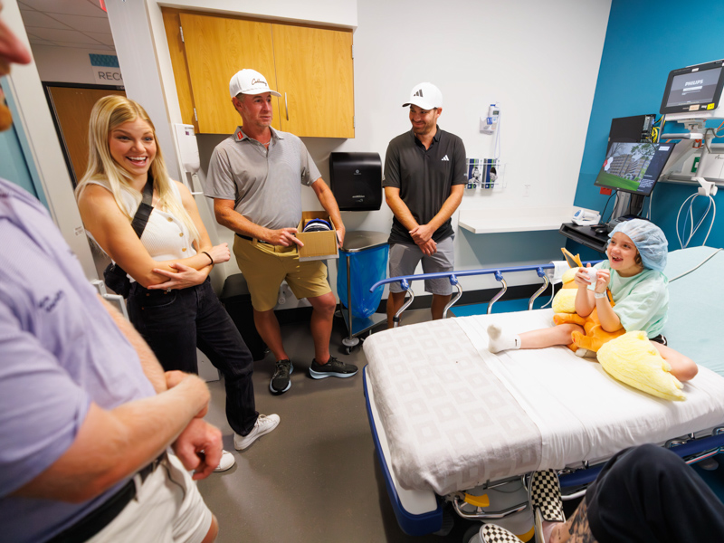 Children's of Mississippi patient Vera Previto, 8, of Biloxi meets, from left, Anders Albertson, Reagan Wise, Vince Covello and Aaron Wise as they tour the hospital ahead of the Sanderson Farms Championship.