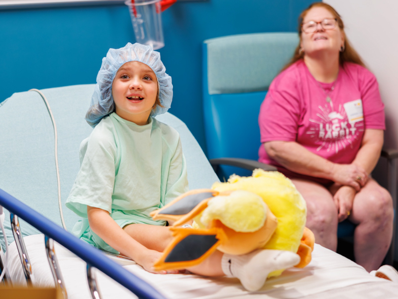 Children's of Mississippi patient Vera Previto, 8, of Biloxi chats with visiting players from the PGA Tour Sanderson Farms Championship.