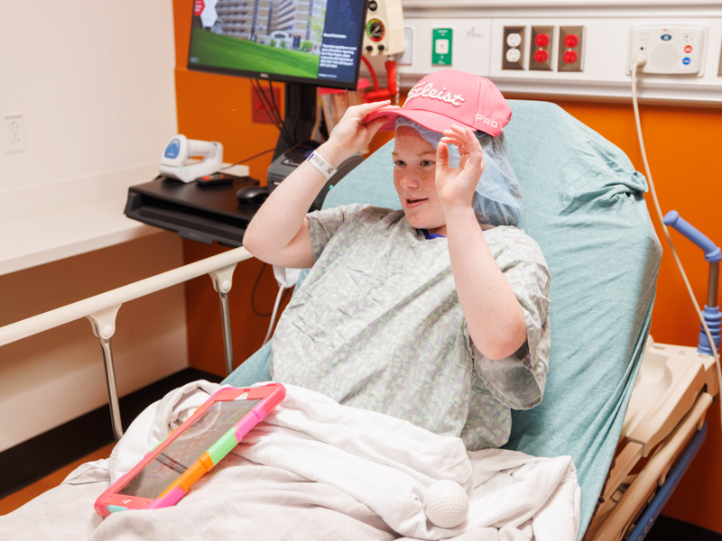 Children's of Mississippi patient Addison Ivy, 17, of Union sports a cap given to her by golfers visiting for the Sanderson Farms Championship.