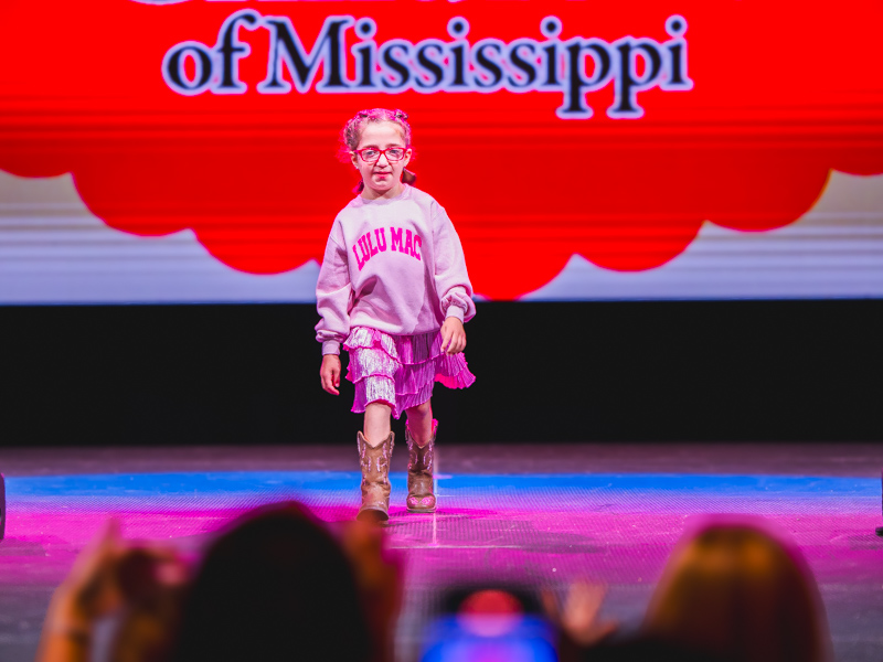 Children's of Mississippi patient and ambassador Emma Porch models a pink pairing.