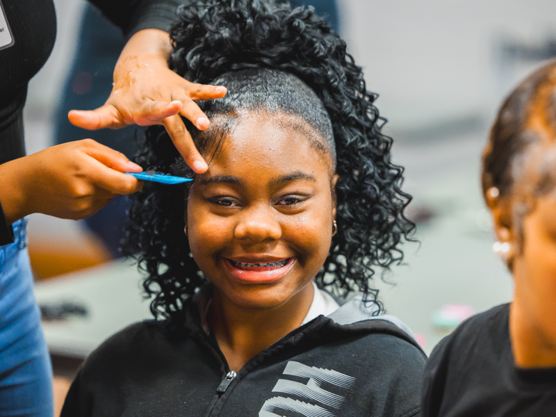 Nolee Jones, the state's 2022 Children's Miracle Network Hospitals Champion, smiles during styling.