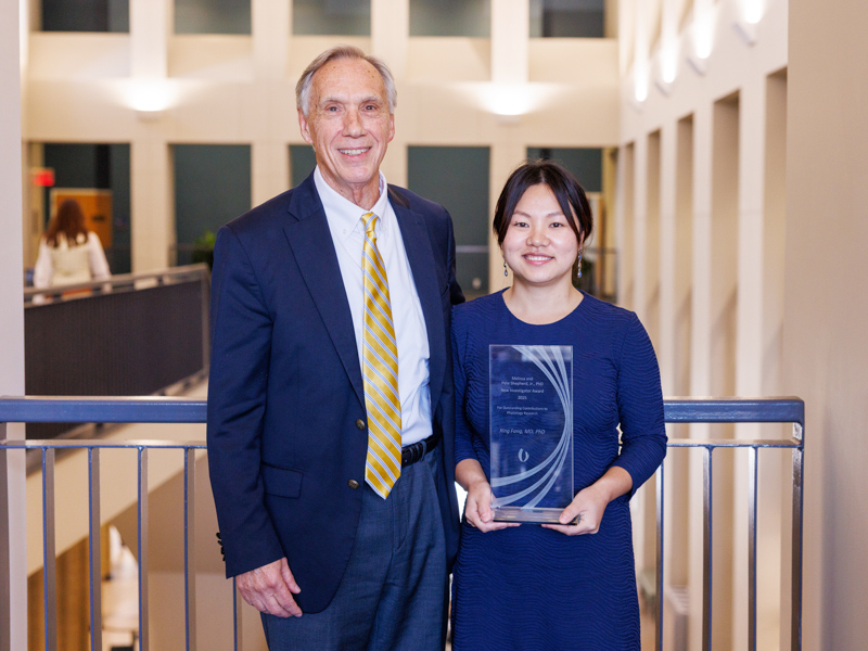 Dr. John Hall, Arthur C. Guyton Professor and chair of the Department of Physiology and Biophysics, congratulates Dr. Xing Fang on winning the Melissa and Pete Shepherd Jr., PhD, New Investigator Prize.