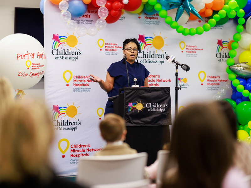 Montoya Sandifer, certified medical assistant at the eli manning clinic, congratulates Porter Antici, Mississippi's 2026 children's miracle network champion.