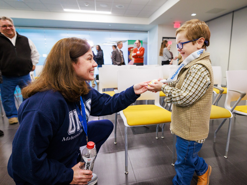 The 2026 Children's Miracle Network Champion, Porter Antici of Madison, greets Dr. Rachael Morris.