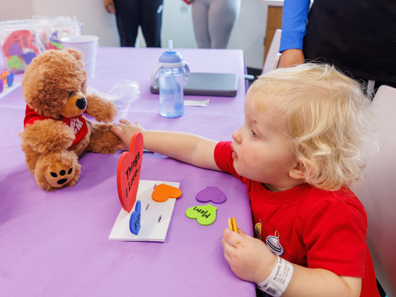 Sawyer Schmidt,1, of Madison, makes a Valentine with his new bear. Jay Ferchaud/ UMMC Communications 