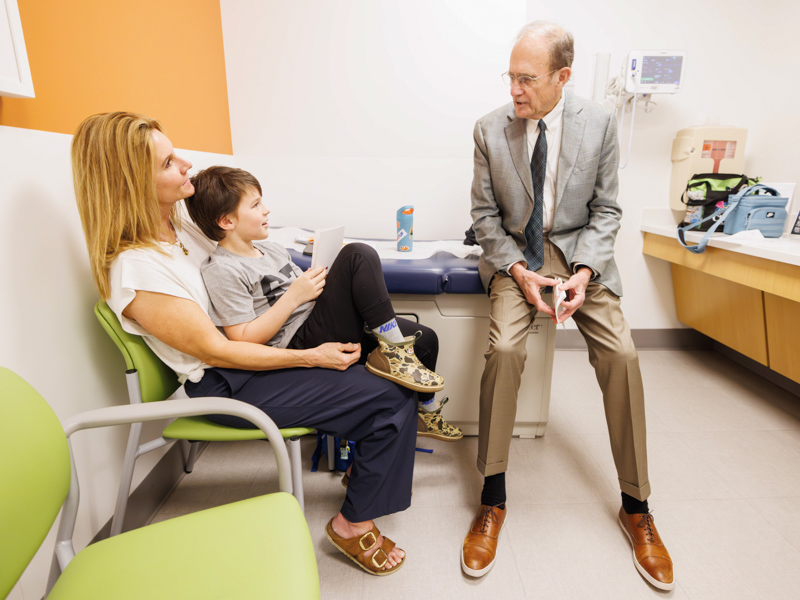 Connor Simon, 7, of Sumrall receives a valentine and a visit from Lt Governor Delbert Hosemann. Melanie Thortis/ UMMC Communications